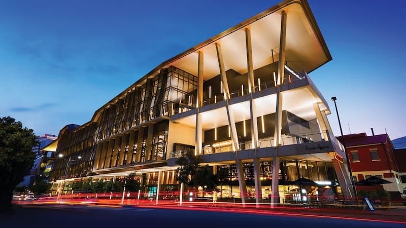 BCEC’s columned facade lit at dusk, with light trails from passing traffic