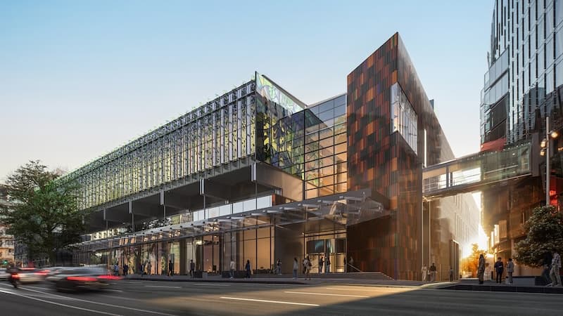 NZICC’s glass and copper-toned facade on Hobson Street at dusk, with the skybridge to SkyCity